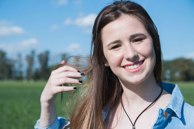 Portrait of beautiful young lady smiling outdoors