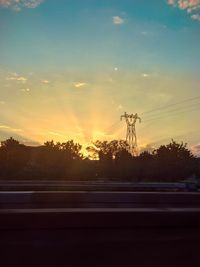 Silhouette of trees against sky at sunset
