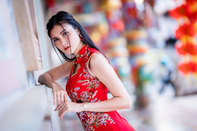 Portrait of beautiful young woman standing outdoors