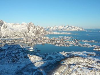 Scenic view of frozen lake against clear blue sky