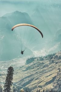 Hot air balloon flying over mountain