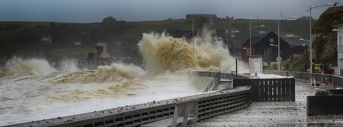 Panoramic view of waves breaking against buildings