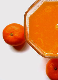 Close-up of red fruit over white background