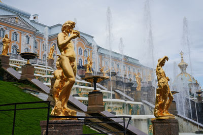 Low angle view of statue against historic building