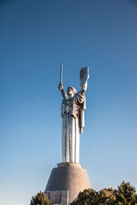 Low angle view of statue against clear blue sky