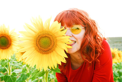 Portrait of young woman with sunflower