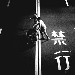 Low section of man skateboarding on road