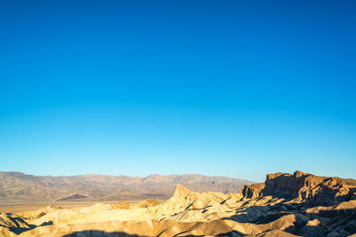 Scenic view of mountains against clear blue sky