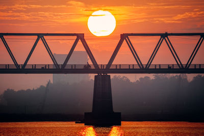 Silhouette of bridge against sky during sunset