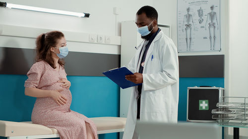 Female doctor examining patient in clinic