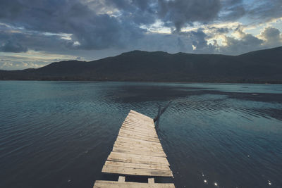 Pier over lake against sky