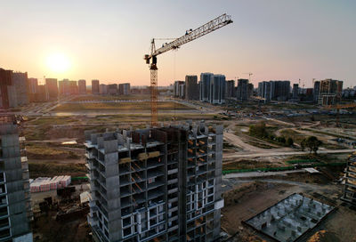 Aerial view of modern buildings against sky during sunset