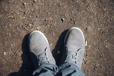 Low section of man standing on ground