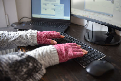 Hands of a woman working from home in winter