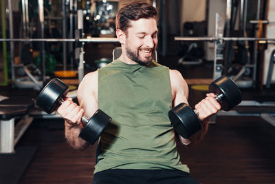 Portrait of young woman exercising in gym