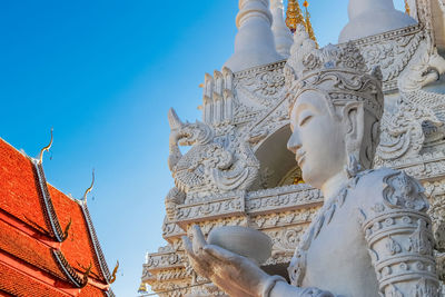 Low angle view of statue against blue sky