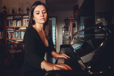 Young woman playing piano