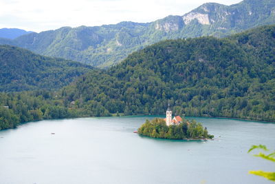 Scenic view of snowcapped mountains against sky with small island known as bled island