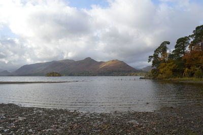 Idyllic shot of river and mountains against cloudy sky