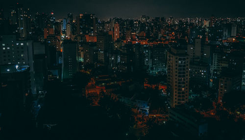 Illuminated modern buildings in city at night