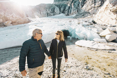 Retired couple enjoying life during outdoor tour to ice cave.