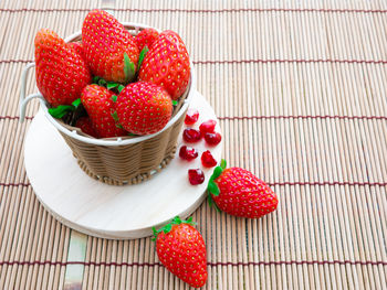 High angle view of strawberries in basket on table