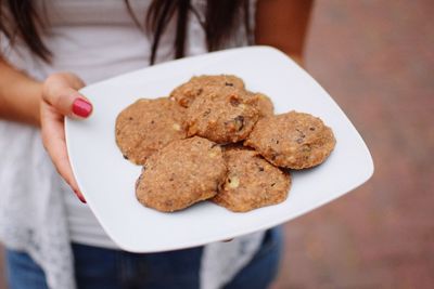 Close-up of woman holding cookies in plate