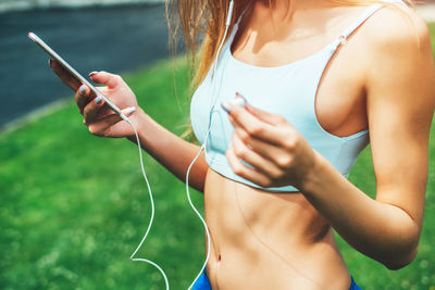 Midsection of woman using mobile phone