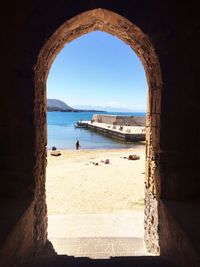 Calm blue sea seen through window