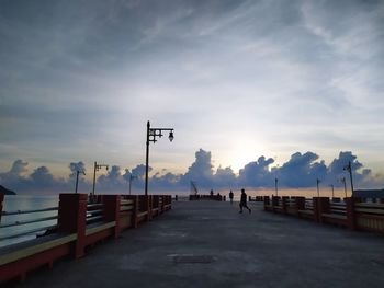 Street against sky during sunset