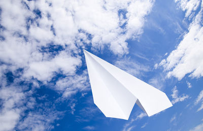 Low angle view of paper flag against blue sky