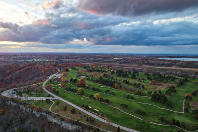 Aerial view of agricultural landscape against sky golf course