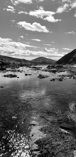 Scenic view of sea and mountains against sky