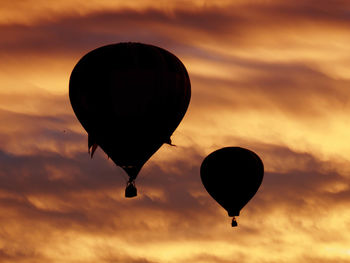 Low angle view of hot air balloon against orange sky