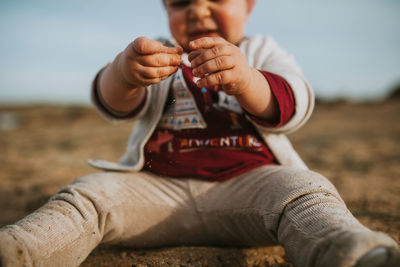 Close-up of baby playing at beach