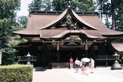 People at temple outside building