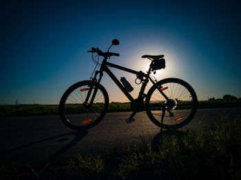 Low angle view of bicycle against clear sky at night