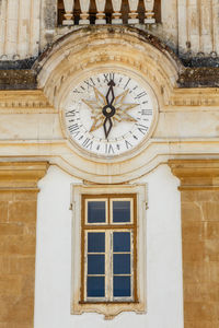 Low angle view of clock on old building