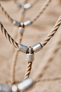 Close-up of rope tied to chain