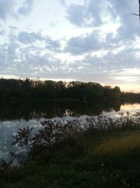 Scenic view of lake against cloudy sky