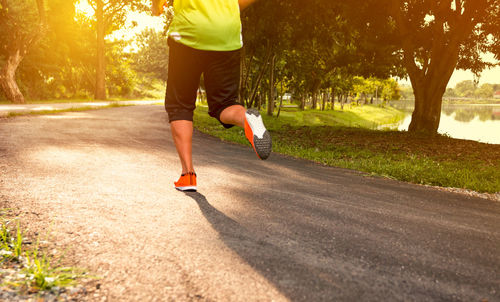 Low section of woman running on road