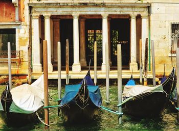 Umbrellas by canal against building