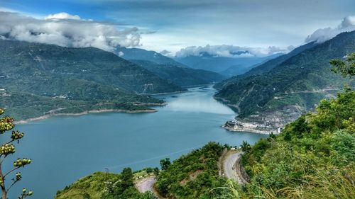 High angle view of lake and mountains against sky