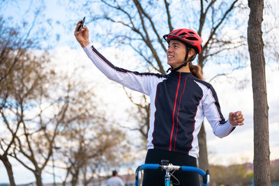 Full length of man with bicycle on tree