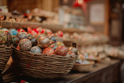 Close-up of colorful easter eggs in wicker baskets for sale in store