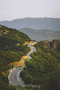 High angle view of road by mountains against clear sky