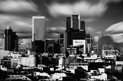 Cityscape against cloudy sky