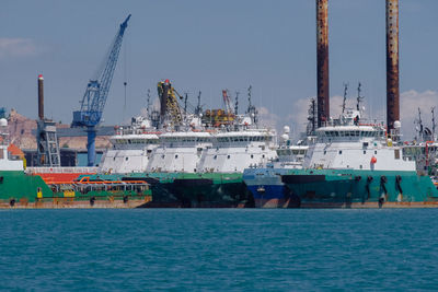 Commercial dock by sea against sky