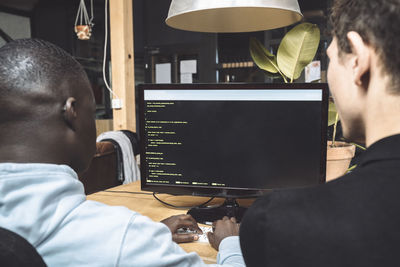 Computer programmers working on coding at workplace