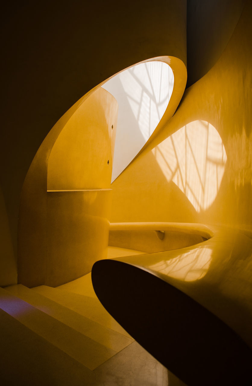 HIGH ANGLE VIEW OF YELLOW WALL WITH REFLECTION ON TILED FLOOR